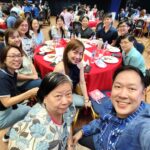 Attendees enjoying food and conversation during the welcome celebration