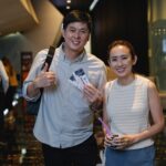 CKSC alumni posing with movie tickets at the cinema lobby