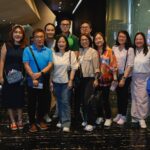 CKSC alumni and friends posing with movie tickets at the cinema lobby