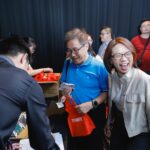 Candid shot of alumni laughing and reconnecting during the event