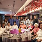 Alumni sharing a toast and smiling during the celebration