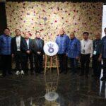CKSC Taiwan Alumni officers posing by a floral backdrop with the association emblem