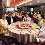 Batchmates smiling and enjoying the dinner event