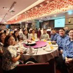 Full table view of alumni and families at the celebration