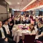 Alumni couples and guests at a round table setup