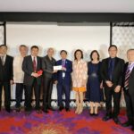 Alumni group posing with smiles during the program