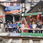 Group dining experience along a famous Vietnam train street