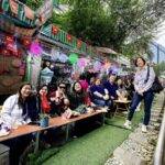 CKSCAA52 members seated beside railway café in Hanoi