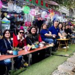 Alumni enjoying street café experience on Vietnam tour