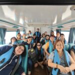 Alumni group seated inside tour bus during Vietnam travel