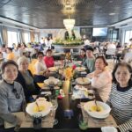 Group meal inside cruise restaurant during Vietnam tour