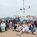 CKSCAA52 members posing on cruise deck with flags