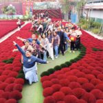 Alumni walking through decorative garden in Vietnam